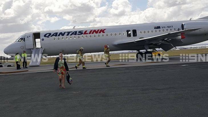 The Qantas link plane evacuated on the runway.  Photo: 9 News Perth 