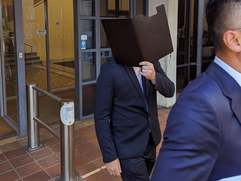 Jailed for grooming: James Anthony Gwynne covers his face following a previous court appearance. (Miklos Bolza/AAP PHOTOS)
