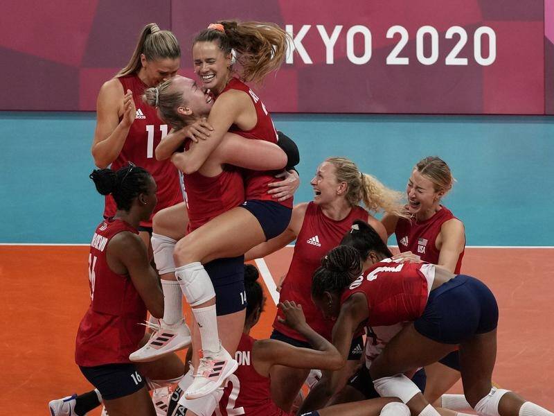 US players celebrate winning their country's maiden Olympic women's volleyball gold medal.